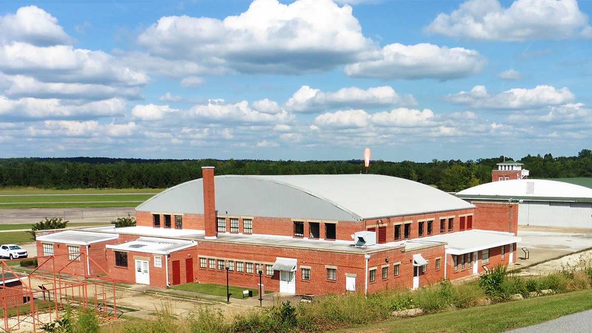 Brick building with cloudy sky backdrop