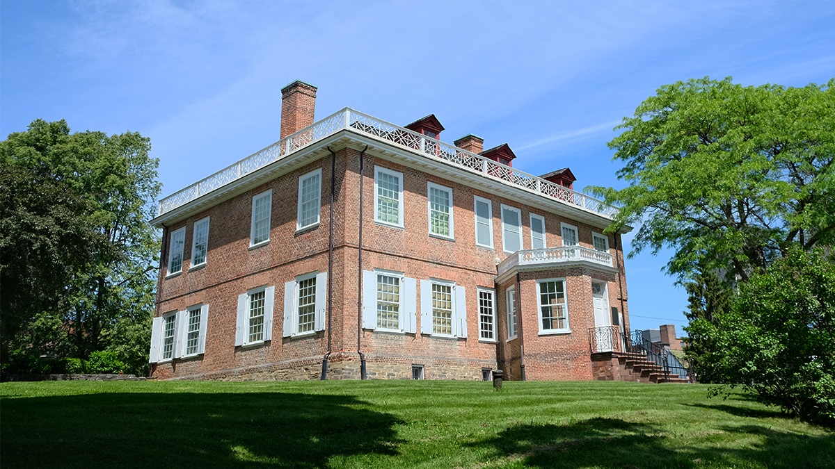 Red brick building in the center; trees on either side
