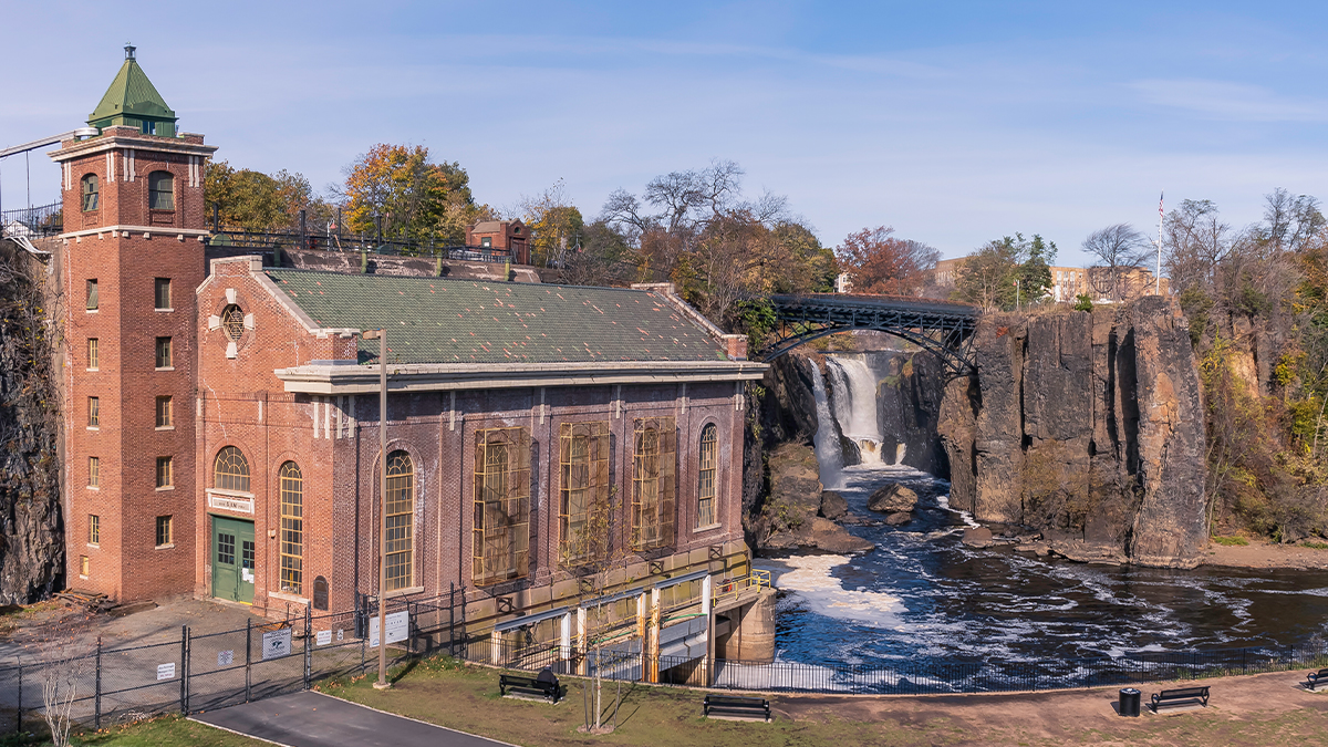 Great Falls Hydroelectric building in foreground; waterfall in background