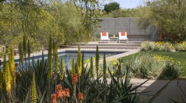 Two chairs overlooking a pool.