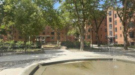Fountain in foreground; buildings and courtyard in background