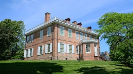 Red brick building in the center; trees on either side