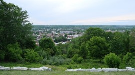 Aerial views of Troy; low stone border at bottom; trees on the left