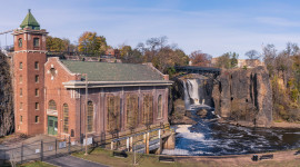 Great Falls Hydroelectric building in foreground; waterfall in background