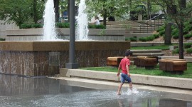A child splashes in the rehabilitated basin of Peavey Plaza, Minneapolis, MN