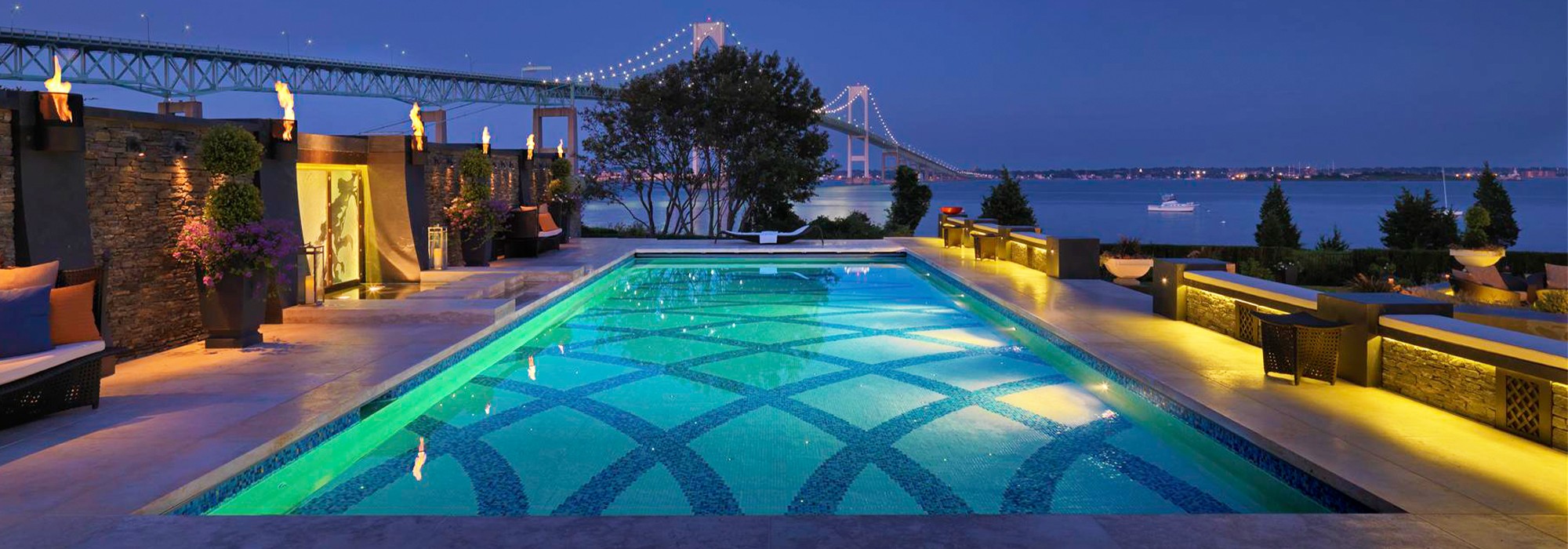 Tiled swimming pool with bridge in background