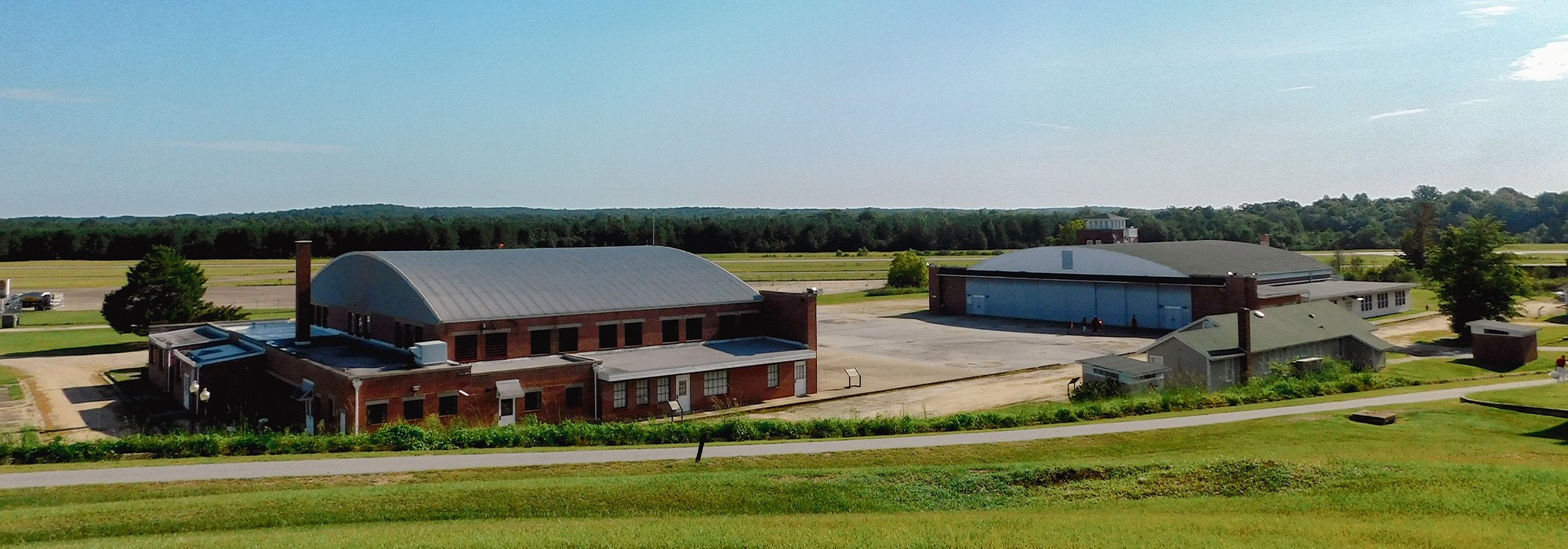 Sloping lawn in foreground; Tuskegee buildings at the base