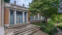 Building with stone path leading to gardens