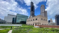 Gardens in foreground; skyscrapers in background