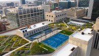 Aerial view of gardens and sport courts; buildings surround