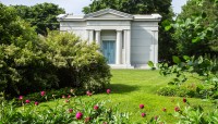 Mausoleum with flowering shrubs in front