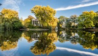 Pond bordered by autumnal trees