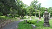 Path on the left, grave markers on the right, trees surround
