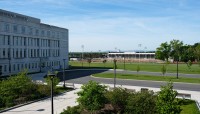 Building on the left, planters and paths in foreground, lawn in background