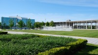Box hedges and path in foreground, fountain and academic buildings behind