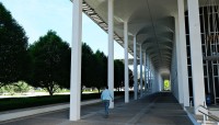 Man walks through colonnade 