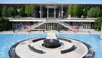 Central fountain surrounded by pool, building in background