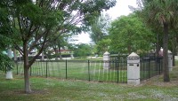 Fence around the memorial; trees outside the border