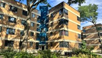 Building with shrubs and trees in front