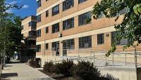 Side of building with ramp and sidewalk