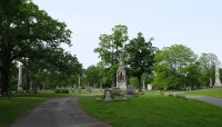 Two paths encircle lawn with grave markers