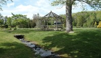 Creek winds past wooden gazebo