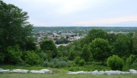 Aerial views of Troy; low stone border at bottom; trees on the left