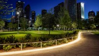 Winding pathway at night; buildings in background