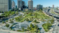 Aerial view of park surrounded by highway and buildings