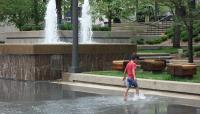 A child splashes in the rehabilitated basin of Peavey Plaza, Minneapolis, MN