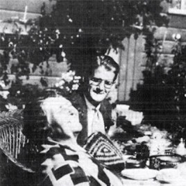 Man sits at outdoor table looking at woman