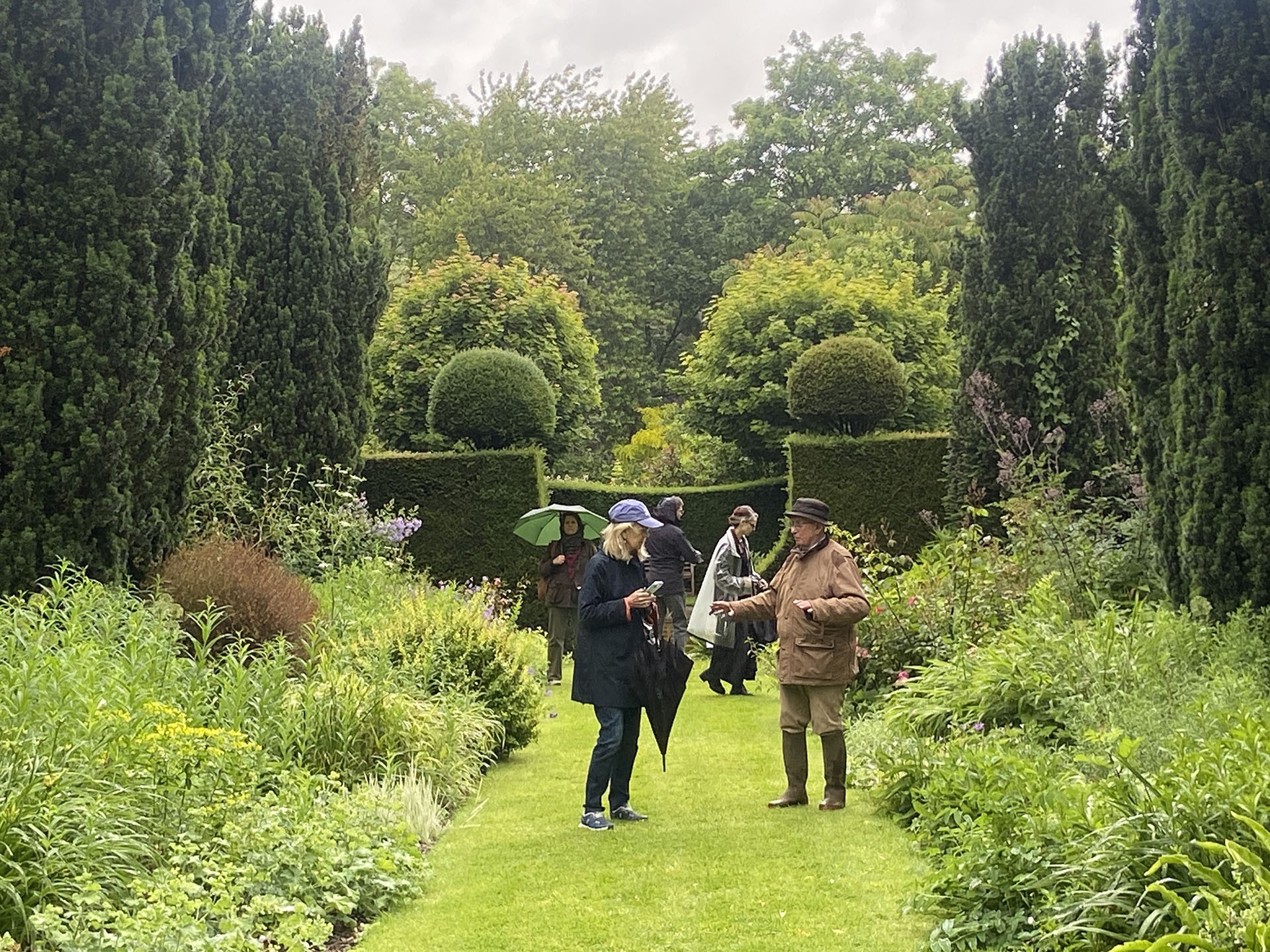 people walking through garden