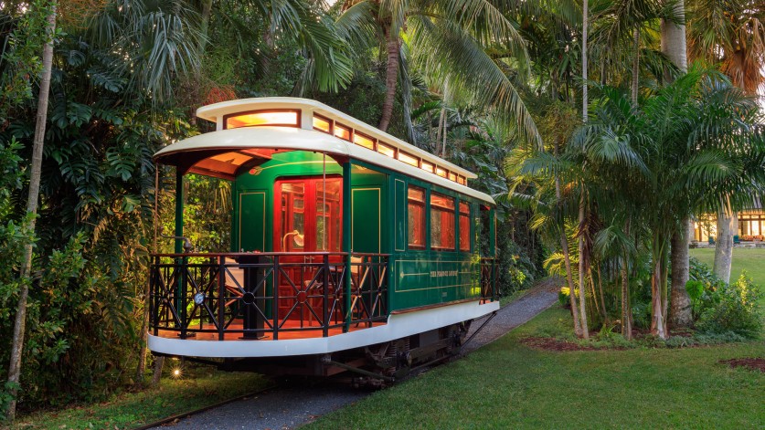 A trolley in a backyard.  