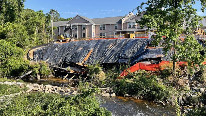 Current effort to prevent the collapse of a parking lot into Carpenter Creek, 2022. Image courtesy Angela Kyle. _sig.jpg Current effort to prevent the collapse of a parking lot into Carpenter Creek