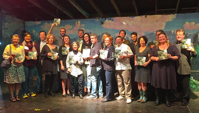 At the launch party for the What's Out There Weekend Austin, attendees show their What's Out There Austin guidebooks